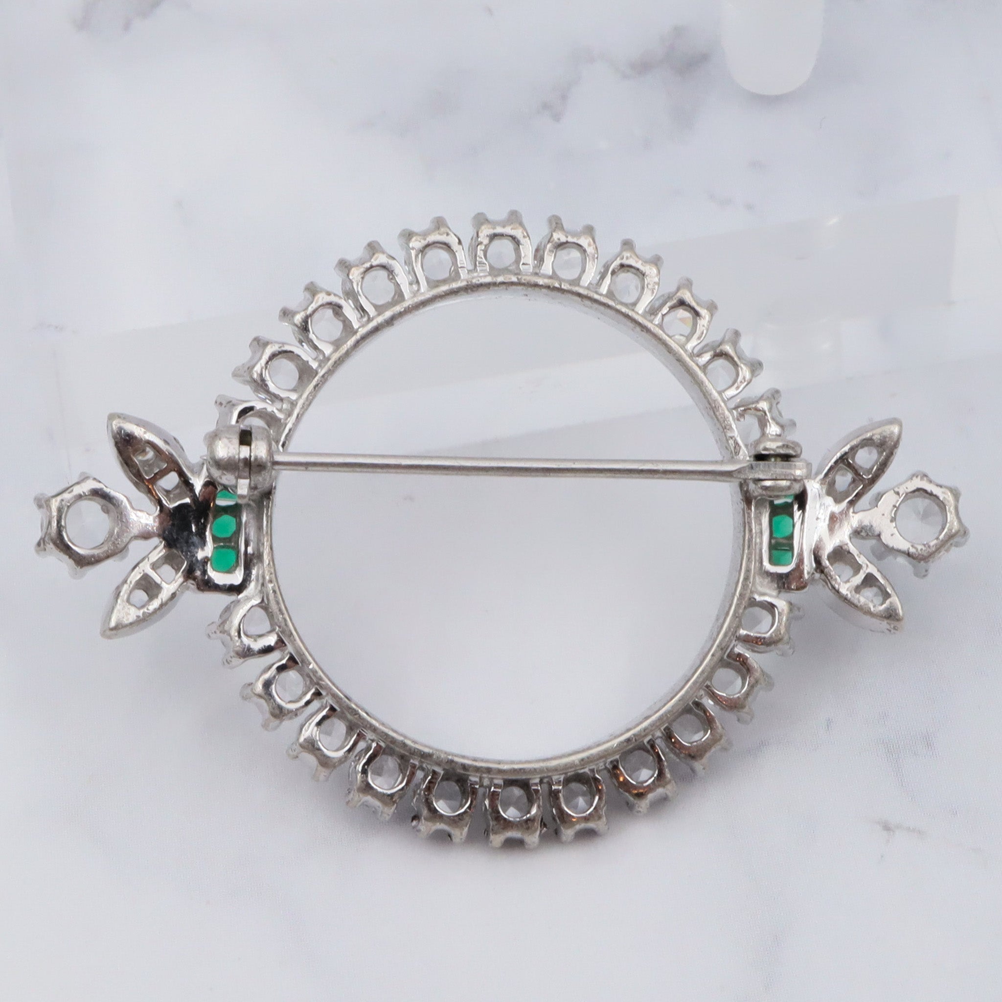 Antique Art Deco rhodium plated sterling, quartz & synthetic emerald circle frame brooch